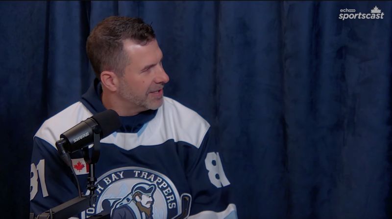 Man wearing a North Bay Trappers hockey shirt participating in a Sportscast podcast